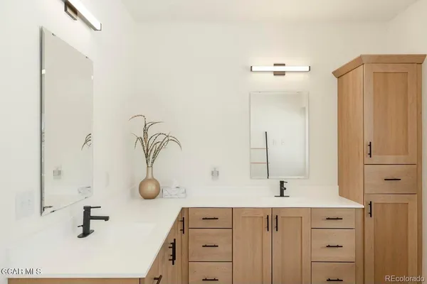 a bathroom with a double vanity sink and mirror