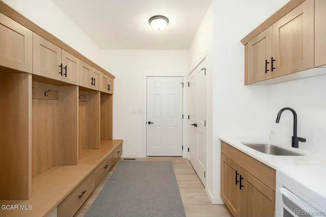 a bathroom with a double vanity sink and a mirror