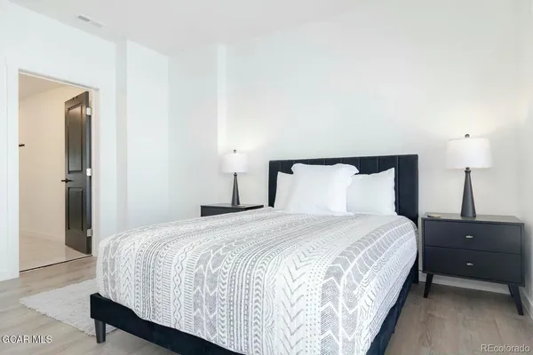 a bedroom with a bed and a night stand