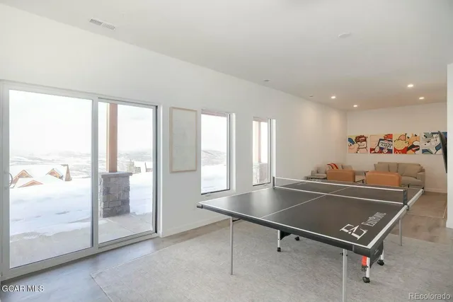 a view of a room with gym equipment and floor to ceiling window