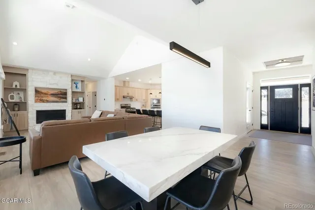 a large white kitchen with a table and chairs