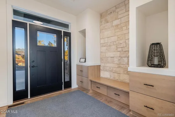 wooden floor with cabinet and mirror
