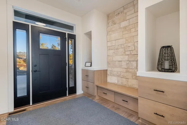 wooden floor with cabinet and mirror