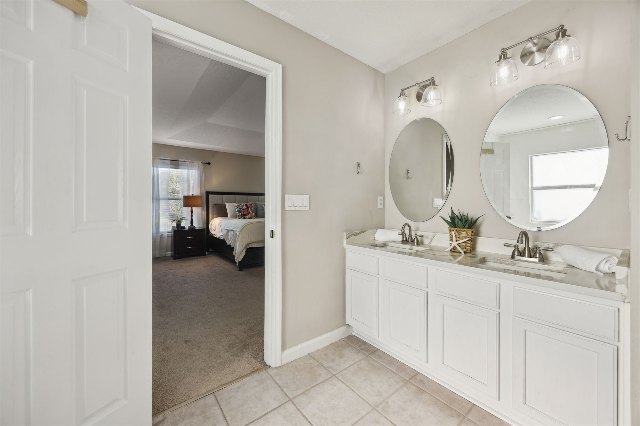 86126 Remsenburg Drive Fernandina Beach, FL 32034 - Photo 16 of 35 a en suite bathroom with double vanity sinks and a mirror