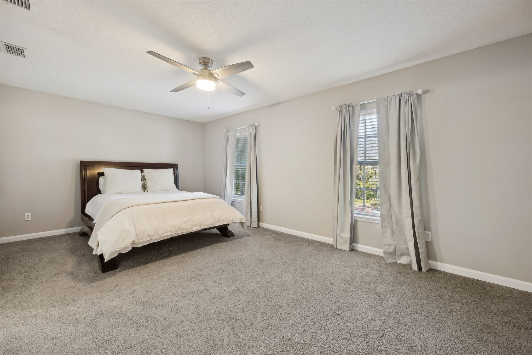 86126 Remsenburg Drive Fernandina Beach, FL 32034 - Photo 19 of 35 a bedroom with a bed and a ceiling fan