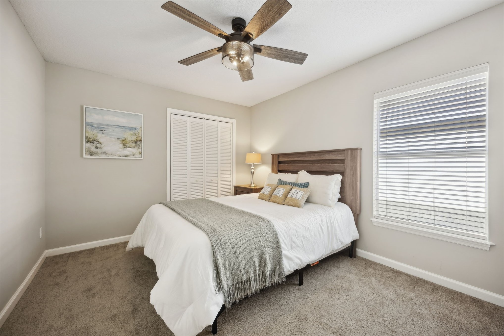 86126 Remsenburg Drive Fernandina Beach, FL 32034 - Photo 21 of 35 a bedroom with a bed and a ceiling fan