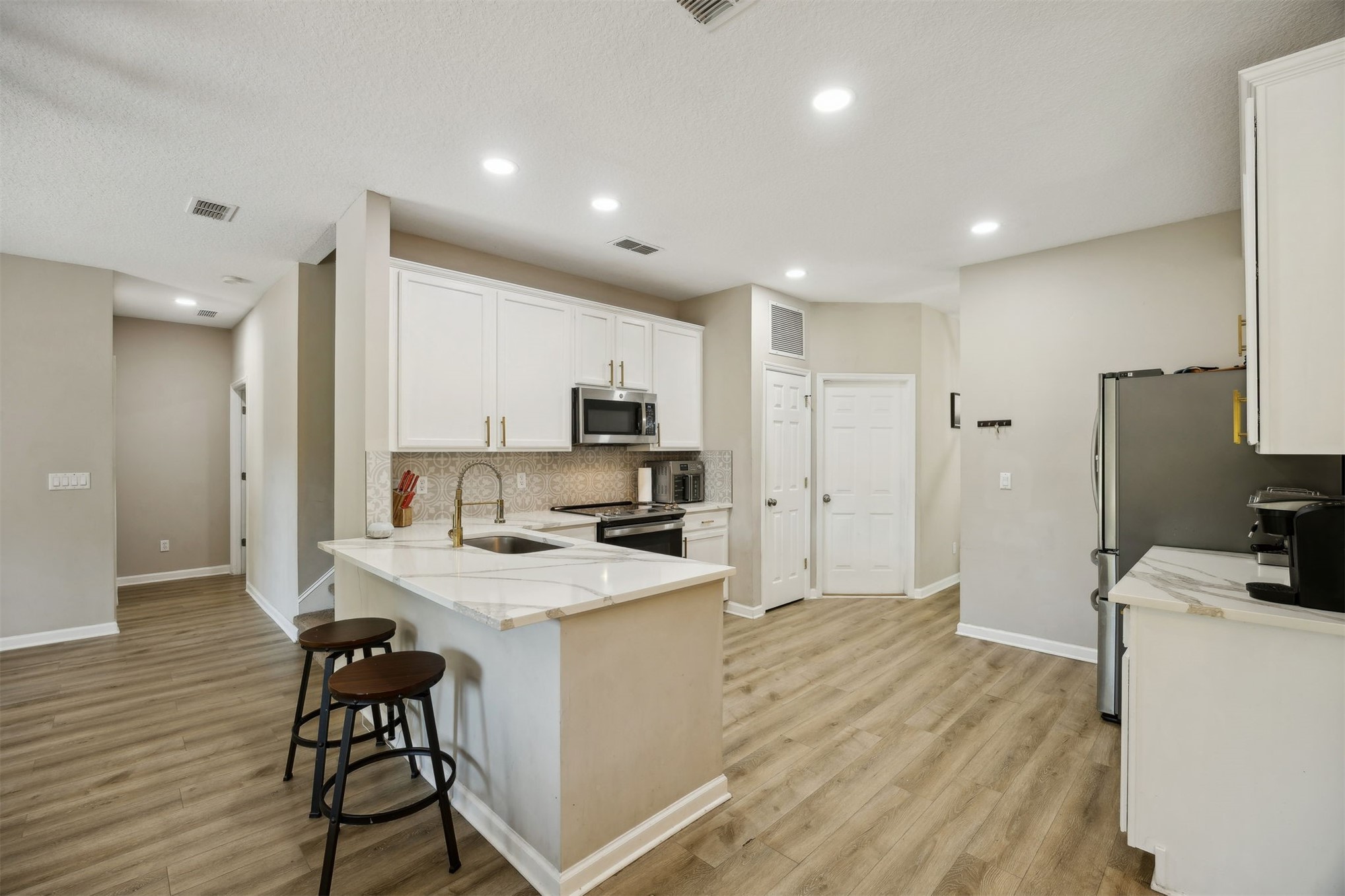 86126 Remsenburg Drive Fernandina Beach, FL 32034 - Photo 6 of 35 a kitchen with a sink a counter top space stainless steel appliances and cabinets