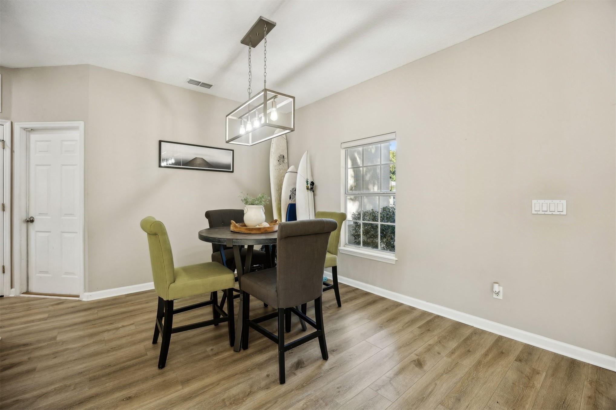 86126 Remsenburg Drive Fernandina Beach, FL 32034 - Photo 9 of 35 a dining room with furniture a chandelier and wooden floor