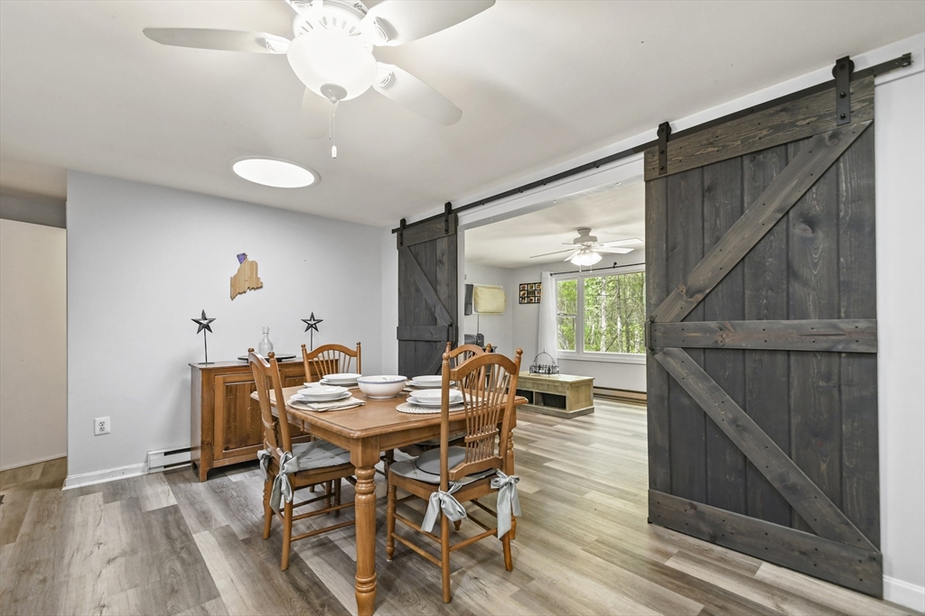 231 Georgetown Road Boxford, MA 01921 - Photo 11 of 28 a dining room with furniture and wooden floor