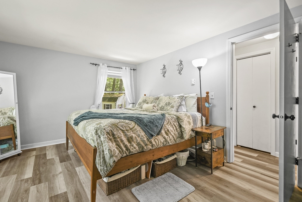 231 Georgetown Road Boxford, MA 01921 - Photo 12 of 28 a bedroom with a bed and wooden floor