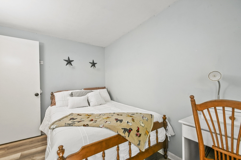 231 Georgetown Road Boxford, MA 01921 - Photo 14 of 28 a bedroom with a bed and wooden floor