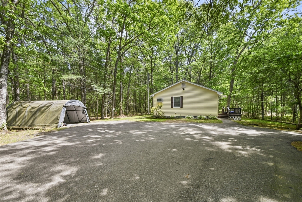 231 Georgetown Road Boxford, MA 01921 - Photo 28 of 28 a view of a house with a yard and large trees