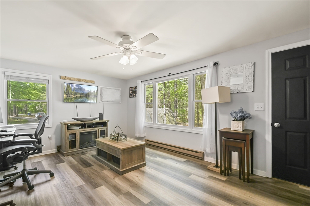 231 Georgetown Road Boxford, MA 01921 - Photo 4 of 28 a living room with furniture a fireplace and a window
