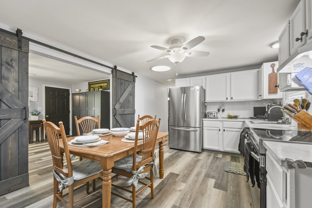 231 Georgetown Road Boxford, MA 01921 - Photo 10 of 28 a view of a dining room with furniture and a kitchen