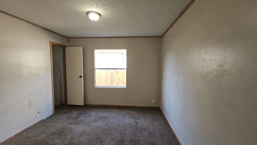 11919 Kingslake Forest Drive Houston, TX 77044 - Photo 8 of 11 an empty room with a window