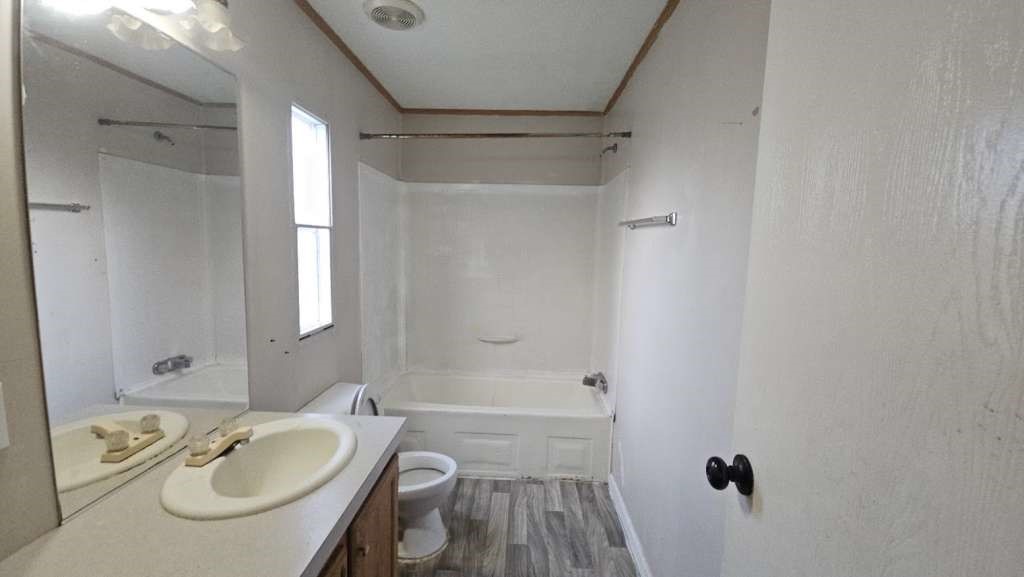 11919 Kingslake Forest Drive Houston, TX 77044 - Photo 9 of 11 a bathroom with a sink a granite tub shower and a mirror