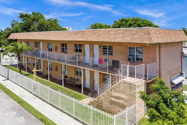 aerial view of a house with large windows and a small yard