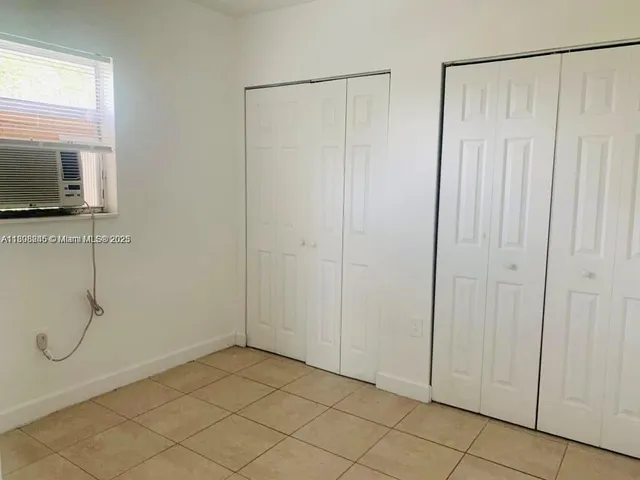 a view of a kitchen with a refrigerator and a stove top oven