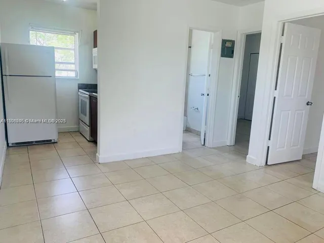 a kitchen with a refrigerator sink stove and cabinets