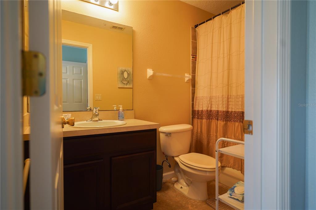 16307 Old Ash Loop Orlando, FL 32828 - Photo 12 of 23 a bathroom with a toilet a sink and a mirror