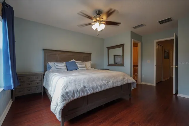 a bedroom with a large bed and a chandelier