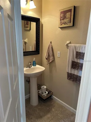 a bathroom with a sink mirror and toilet