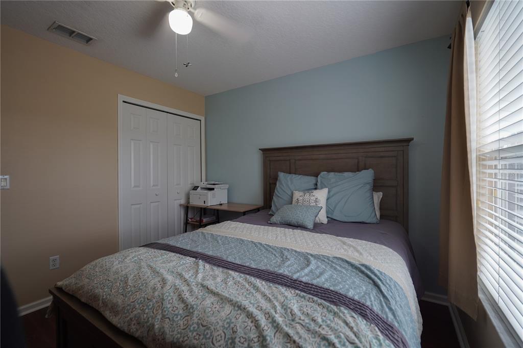 16307 Old Ash Loop Orlando, FL 32828 - Photo 17 of 26 a bedroom with a bed and a window