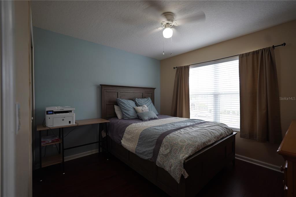 16307 Old Ash Loop Orlando, FL 32828 - Photo 18 of 26 a bedroom with a bed and a window