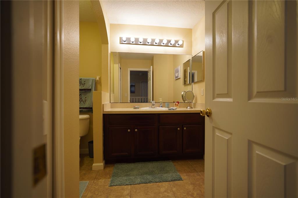 16307 Old Ash Loop Orlando, FL 32828 - Photo 20 of 26 a bathroom with a sink and a mirror
