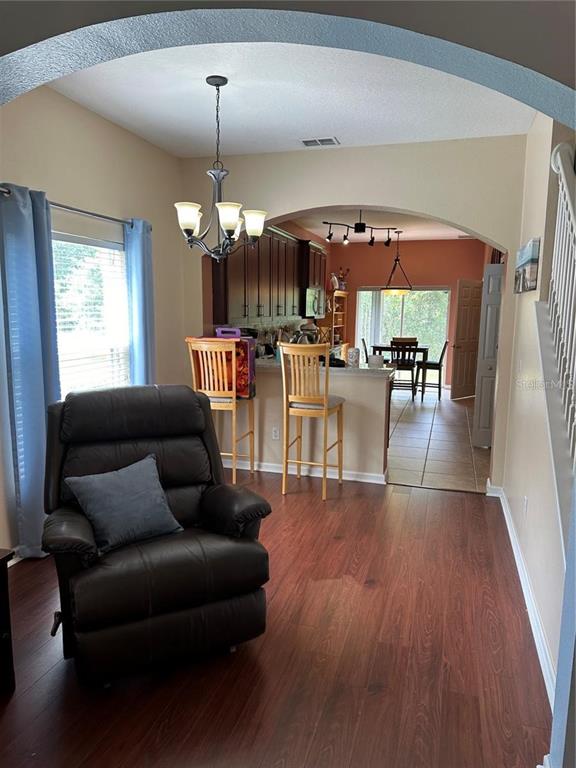 16307 Old Ash Loop Orlando, FL 32828 - Photo 2 of 26 a living room with furniture a window and appliances