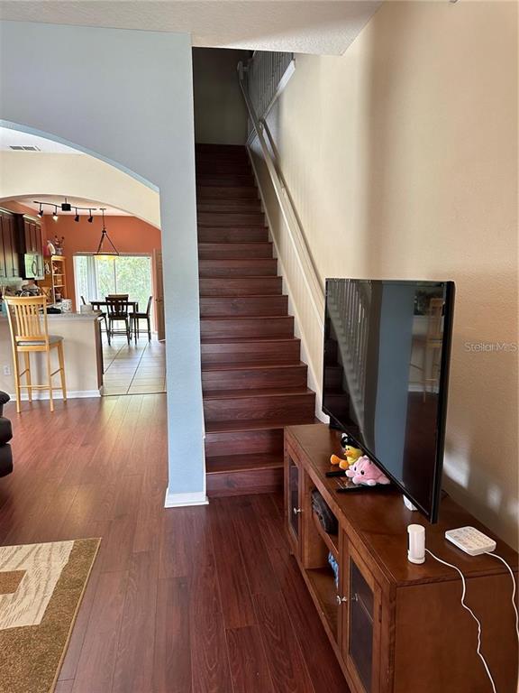 16307 Old Ash Loop Orlando, FL 32828 - Photo 4 of 26 a room with wooden floor and furniture