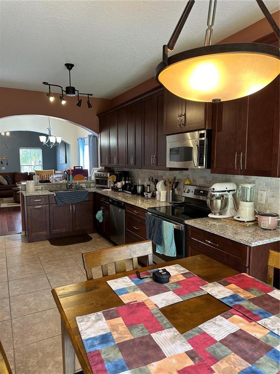16307 Old Ash Loop Orlando, FL 32828 - Photo 6 of 23 a kitchen with lots of appliances and cabinets