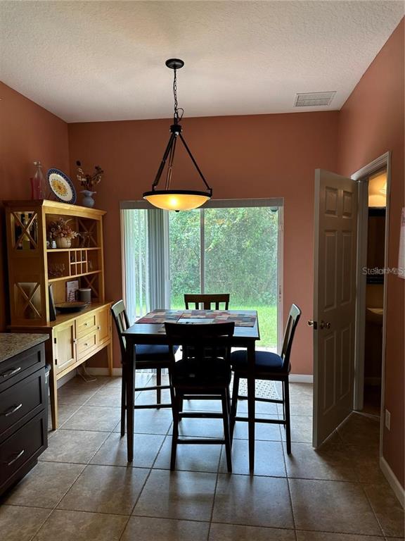16307 Old Ash Loop Orlando, FL 32828 - Photo 7 of 26 a view of a dining room with furniture window and outside view