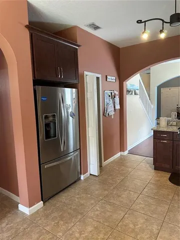 a kitchen with stainless steel appliances granite countertop a refrigerator and a stove