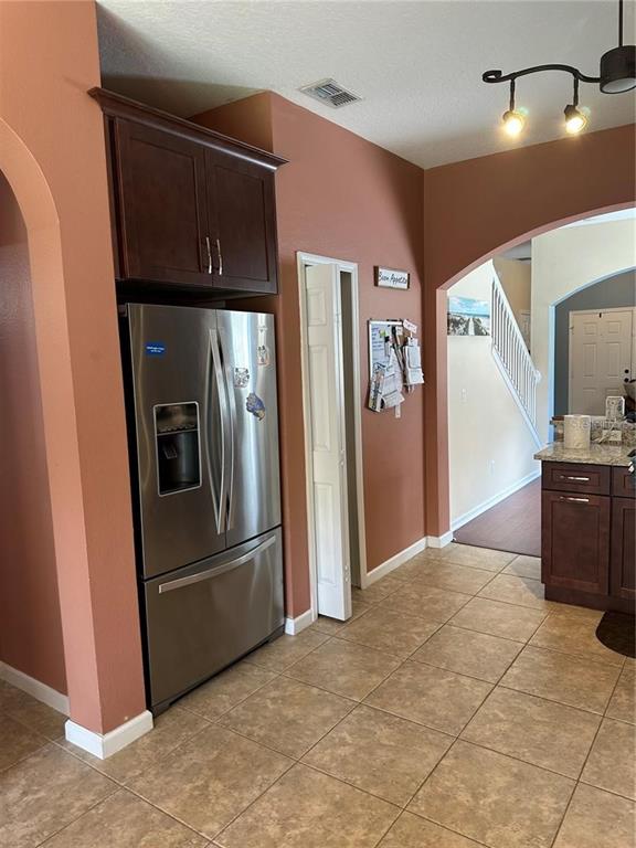 16307 Old Ash Loop Orlando, FL 32828 - Photo 9 of 26 a kitchen with stainless steel appliances granite countertop a refrigerator and a stove