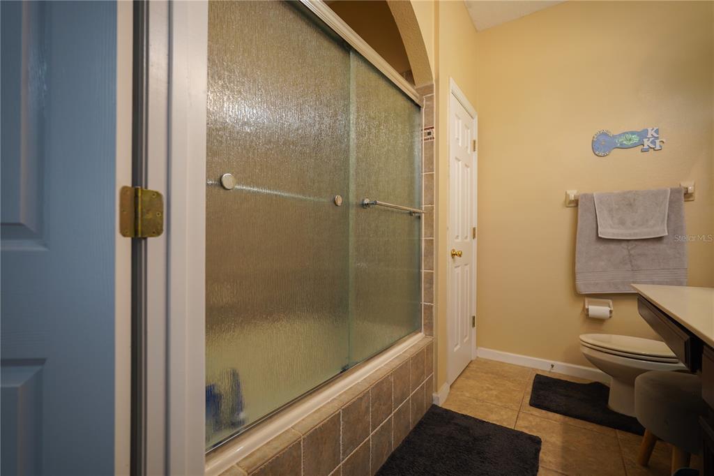 16307 Old Ash Loop Orlando, FL 32828 - Photo 10 of 23 a bathroom with a bathtub and a shower