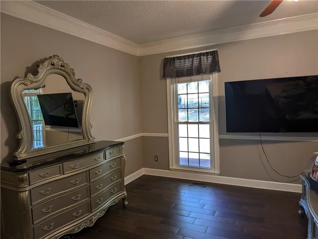 a view of room with window and wooden floor