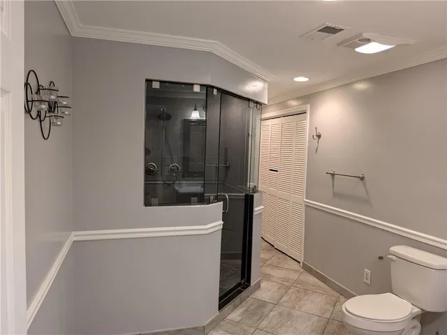 a bathroom with a shower a toilet and sink