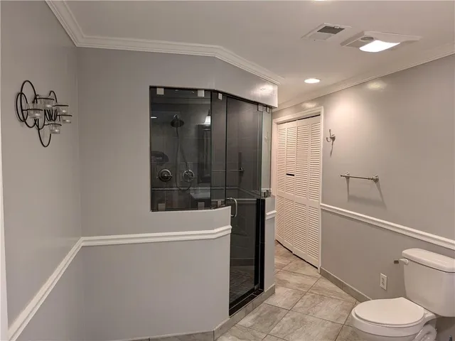 a bathroom with a shower a toilet and sink