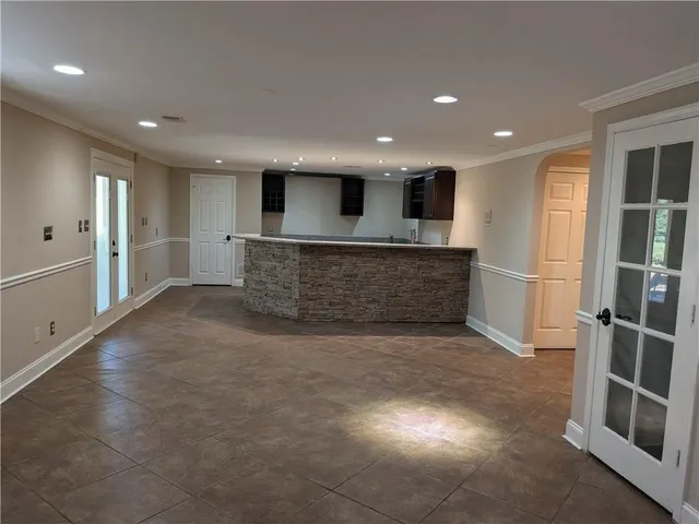 a living room with a fireplace and a refrigerator