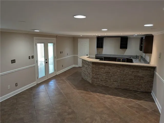 a large kitchen with stainless steel appliances a large counter top and stove