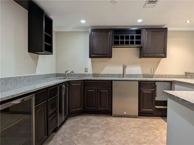 a kitchen with stainless steel appliances granite countertop a sink and a stove top oven