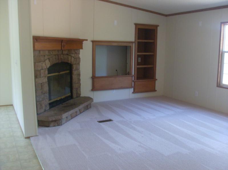 108 Westgrove Road Blue Ridge, VA 24064 - Photo 7 of 24 an empty room with a fireplace and cabinet