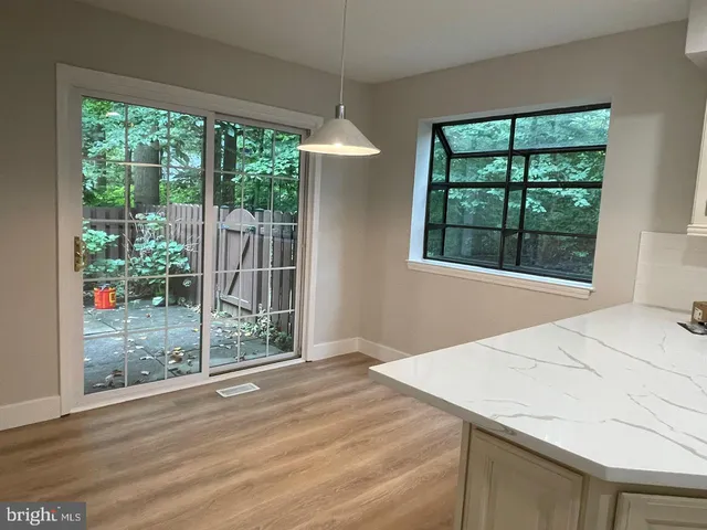 a view of a room that has a bed and a window