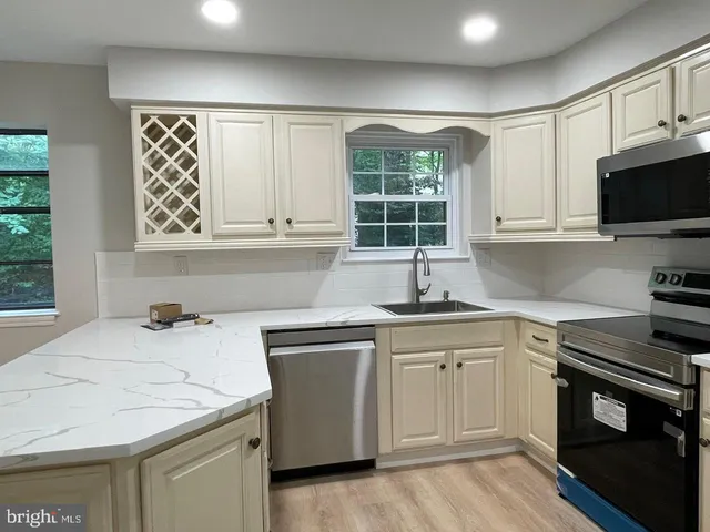 a kitchen with a sink stove and microwave