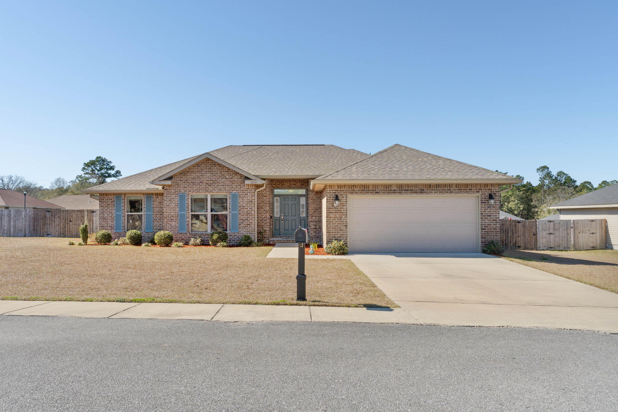 3633 Ranch Drive Crestview, FL 32539 - Photo 1 of 13 a front view of a house with a yard and garage