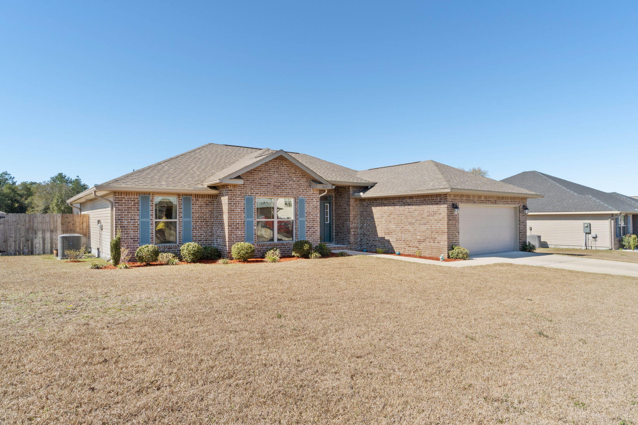 3633 Ranch Drive Crestview, FL 32539 - Photo 2 of 13 a front view of a house with a yard and garage