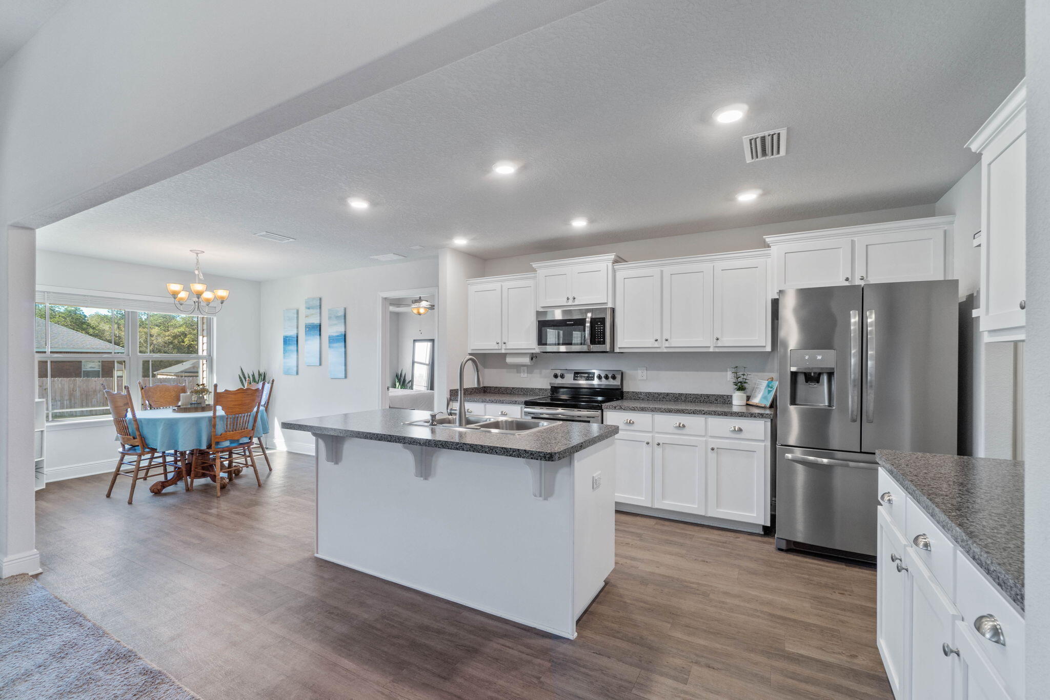 3633 Ranch Drive Crestview, FL 32539 - Photo 5 of 13 a kitchen with stainless steel appliances kitchen island granite countertop a stove and a refrigerator