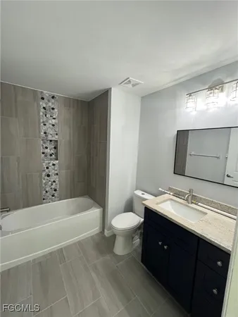 a bathroom with a double vanity sink toilet and shower