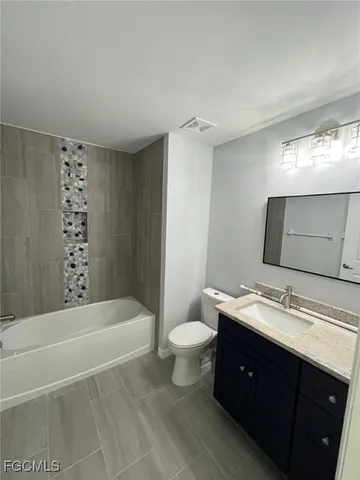 a bathroom with a double vanity sink toilet and shower